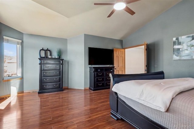 bedroom featuring vaulted ceiling, dark wood-style flooring, a ceiling fan, and baseboards