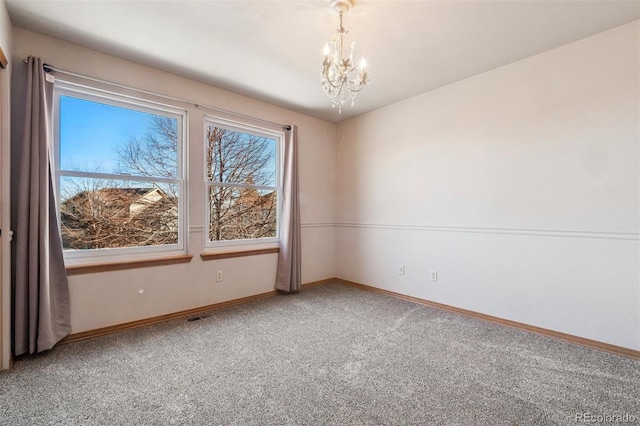 unfurnished room featuring a chandelier, visible vents, carpet floors, and baseboards