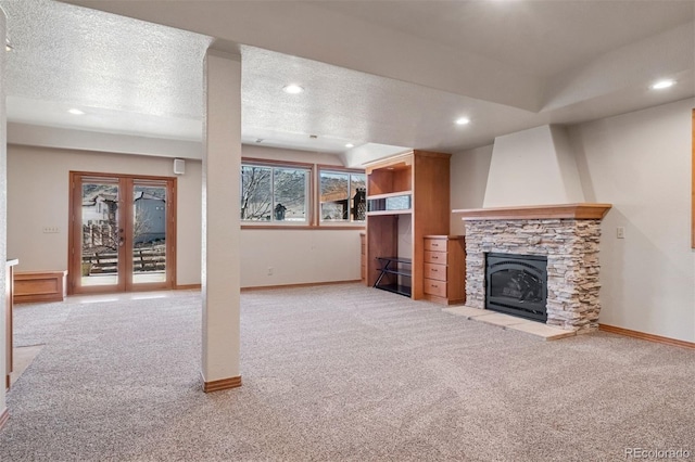 unfurnished living room featuring a textured ceiling, carpet, and baseboards