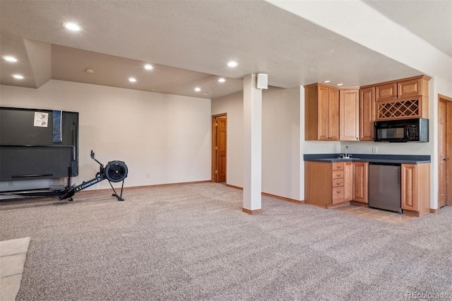 kitchen with recessed lighting, black microwave, dishwasher, and light colored carpet