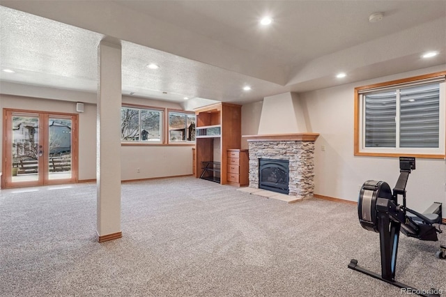 workout room with carpet, a fireplace, recessed lighting, a textured ceiling, and baseboards