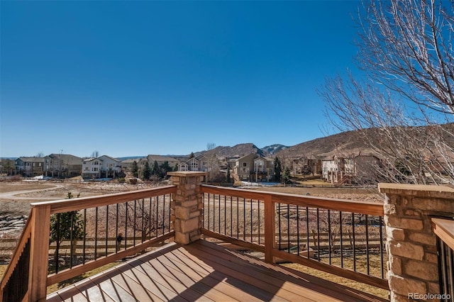 wooden deck featuring a residential view and a mountain view