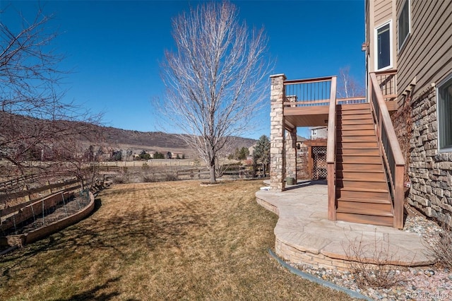 view of yard with stairs, a patio, and a wooden deck