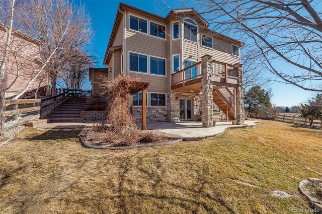 back of house with stairs, a yard, a patio area, and fence