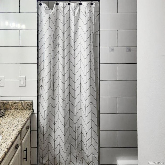 bathroom with vanity and walk in shower