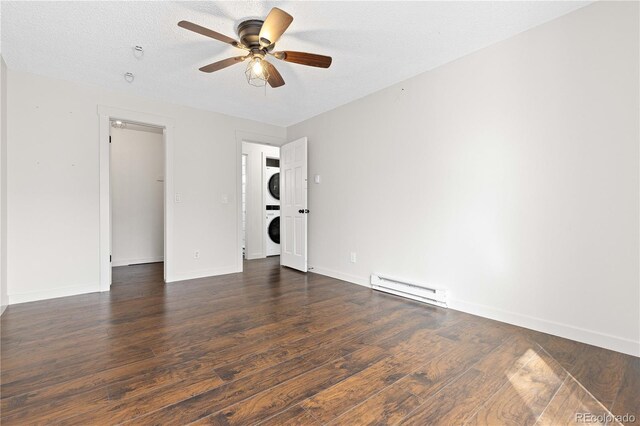 4062 S Atchison Way Unit 302, Aurora, CO 80014 - unfurnished bedroom featuring stacked washer / drying machine, a baseboard radiator, wood finished floors, baseboards, and a textured ceiling