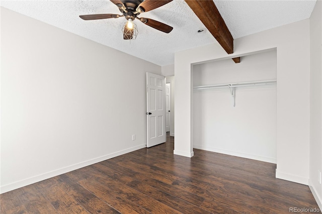 4062 S Atchison Way Unit 302, Aurora, CO 80014 - unfurnished bedroom featuring a textured ceiling, beamed ceiling, dark wood-style flooring, a closet, and baseboards