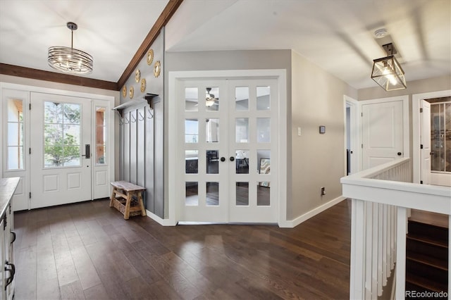 entryway with baseboards, dark wood-style flooring, and a chandelier