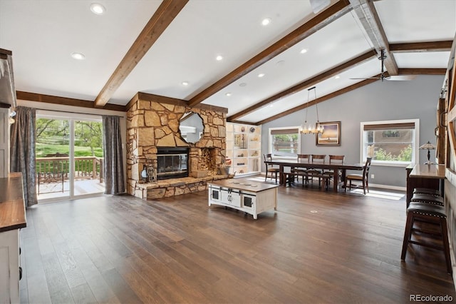 living room featuring plenty of natural light, dark wood finished floors, and a fireplace