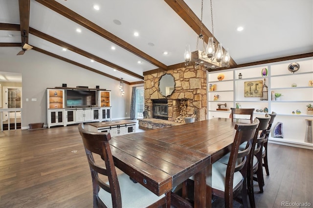 dining area with wood finished floors, a fireplace, and a chandelier