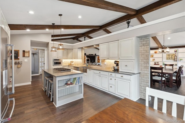 kitchen with appliances with stainless steel finishes, open shelves, a chandelier, tasteful backsplash, and white cabinets