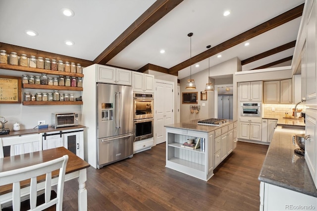 kitchen with stainless steel appliances, open shelves, a sink, decorative backsplash, and dark stone counters