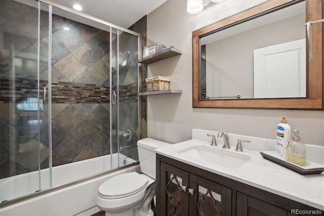 full bath featuring combined bath / shower with glass door, toilet, and vanity