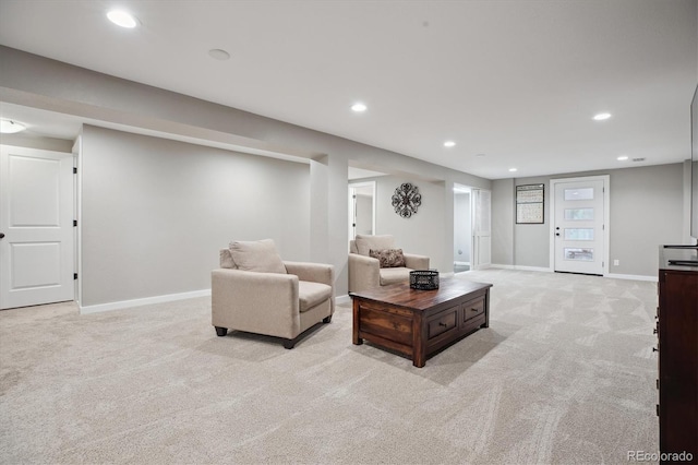 living area featuring light carpet, baseboards, and recessed lighting