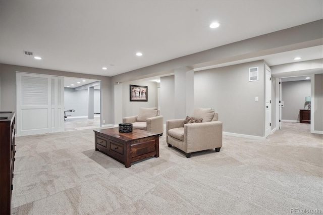 living area featuring light carpet, recessed lighting, and baseboards