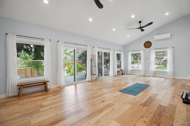 workout room featuring ceiling fan, a wall mounted AC, light wood-type flooring, plenty of natural light, and recessed lighting
