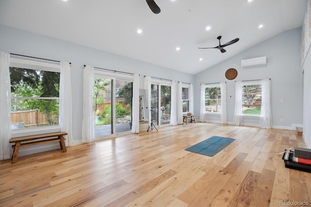 workout room with a ceiling fan, an AC wall unit, light wood-type flooring, high vaulted ceiling, and recessed lighting