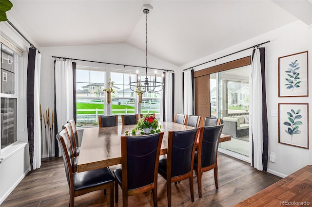 dining space featuring vaulted ceiling, dark wood-style flooring, baseboards, and a notable chandelier