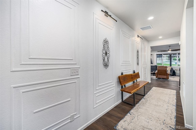 hallway featuring baseboards, dark wood-style flooring, visible vents, and recessed lighting