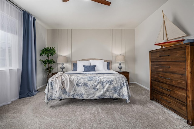 bedroom with ceiling fan, baseboards, and carpet flooring