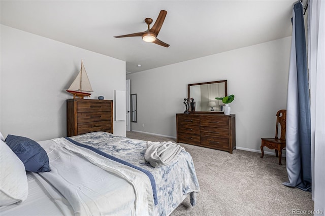 bedroom featuring baseboards, a ceiling fan, and light colored carpet