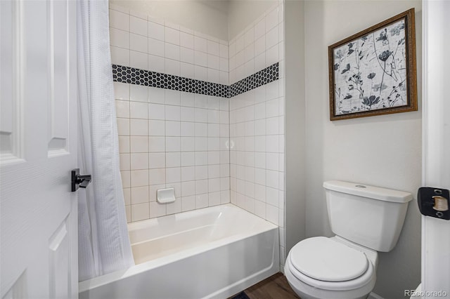 bathroom featuring toilet, shower / bathtub combination with curtain, and wood finished floors