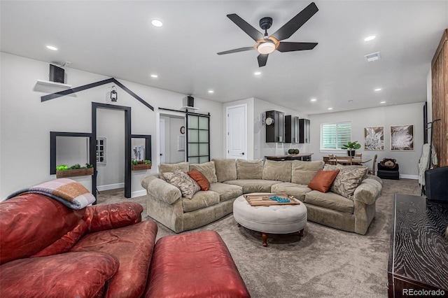 living area featuring ceiling fan, a barn door, recessed lighting, visible vents, and carpet