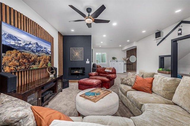 living room with recessed lighting, a fireplace, and light colored carpet