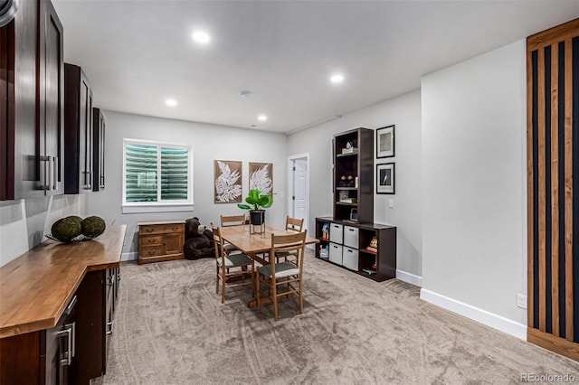 dining area featuring recessed lighting, light colored carpet, and baseboards