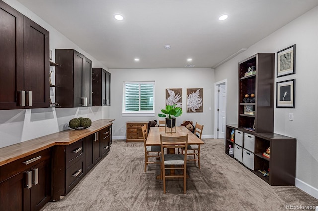 dining area with recessed lighting, light carpet, and baseboards