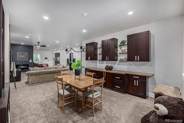 dining area with recessed lighting, a fireplace, a ceiling fan, and light colored carpet