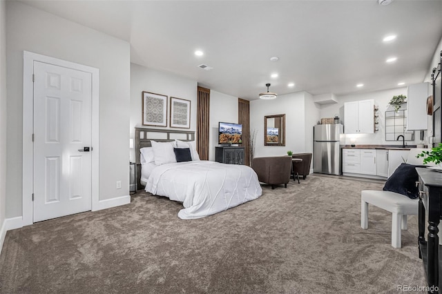 bedroom featuring light carpet, recessed lighting, visible vents, and freestanding refrigerator