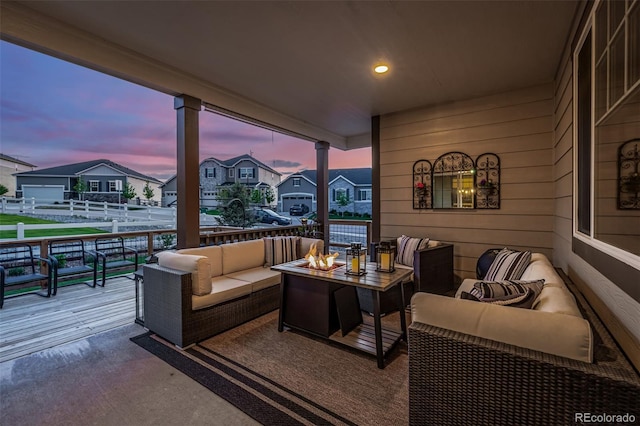 patio terrace at dusk featuring a residential view and outdoor lounge area