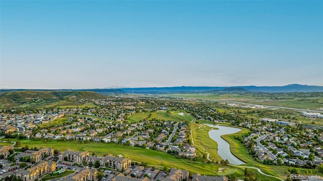 birds eye view of property with golf course view, a residential view, and a water and mountain view