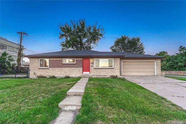 single story home featuring a front yard and a garage