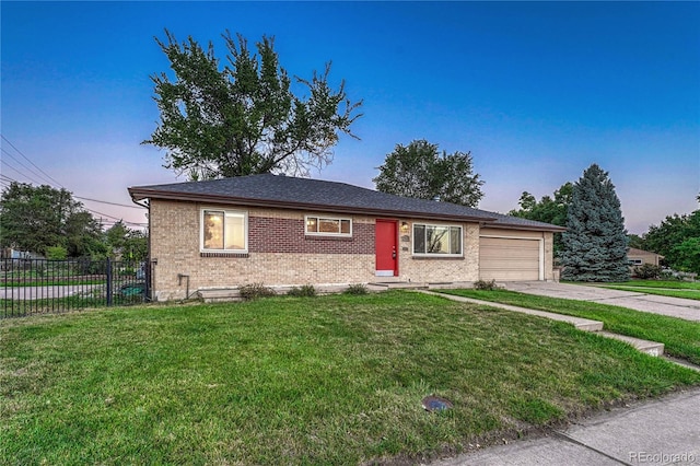 view of front of house with a yard and a garage