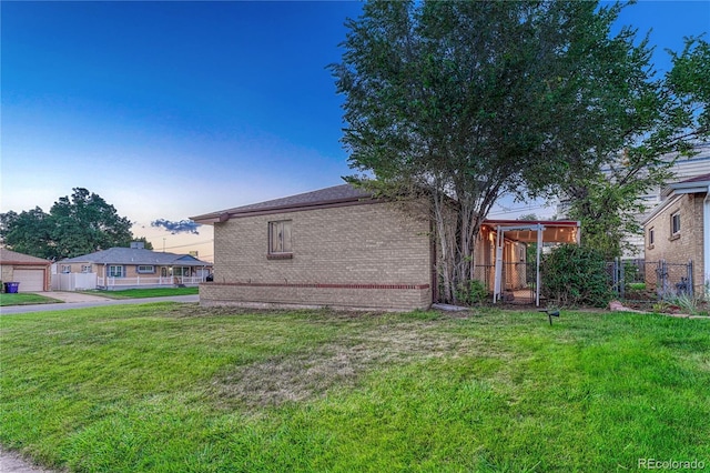 property exterior at dusk with a yard