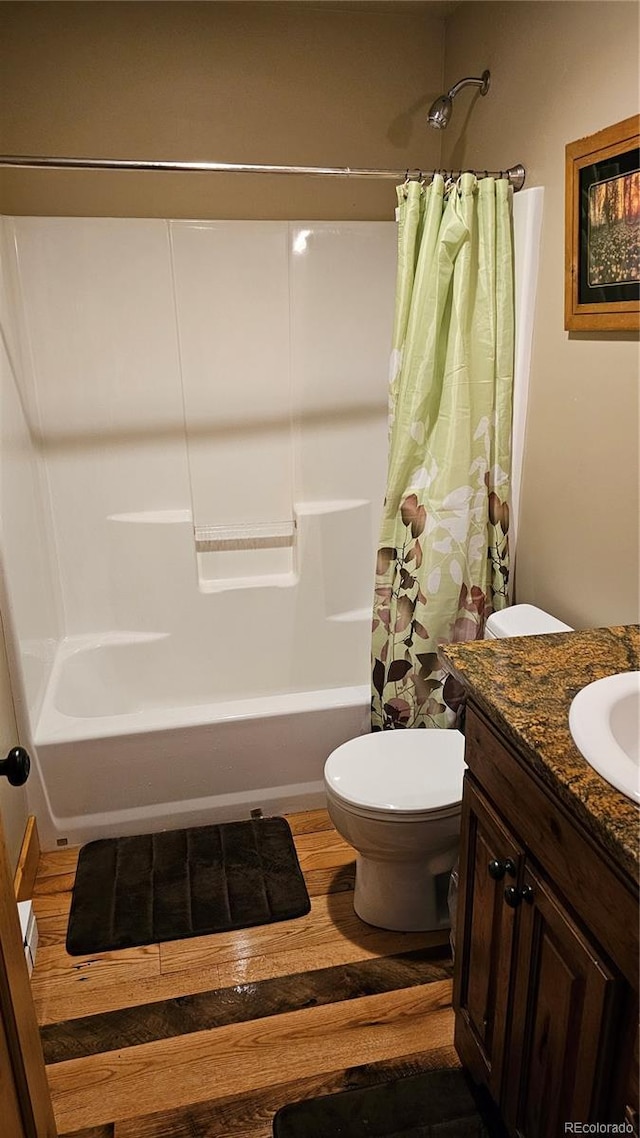 bathroom featuring shower / tub combo, vanity, toilet, and wood finished floors