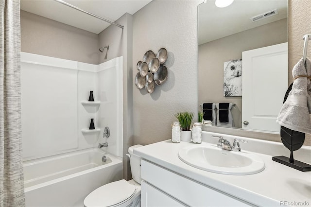 full bathroom with vanity, shower / tub combo, and toilet