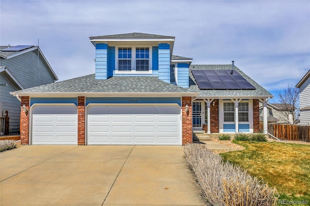 19939 E Belleview Ln, Centennial, CO 80015 - traditional-style home with brick siding, solar panels, concrete driveway, and fence