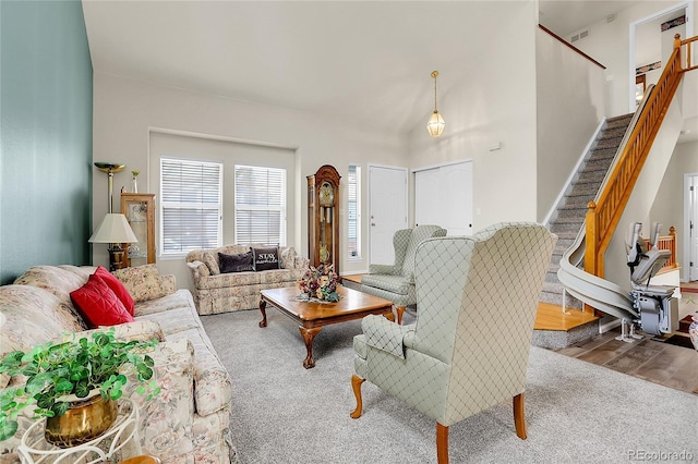 19939 E Belleview Ln, Centennial, CO 80015 - carpeted living area featuring visible vents, wood finished floors, and stairway