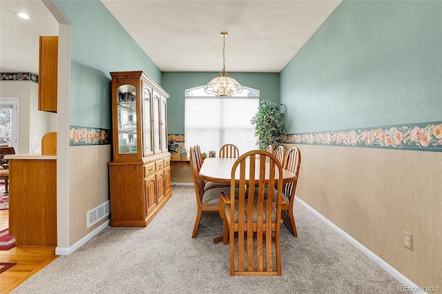 19939 E Belleview Ln, Centennial, CO 80015 - dining space featuring arched walkways, an inviting chandelier, light colored carpet, baseboards, and visible vents