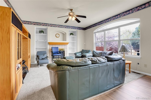 19939 E Belleview Ln, Centennial, CO 80015 - living room featuring visible vents, baseboards, built in features, a ceiling fan, and a tile fireplace