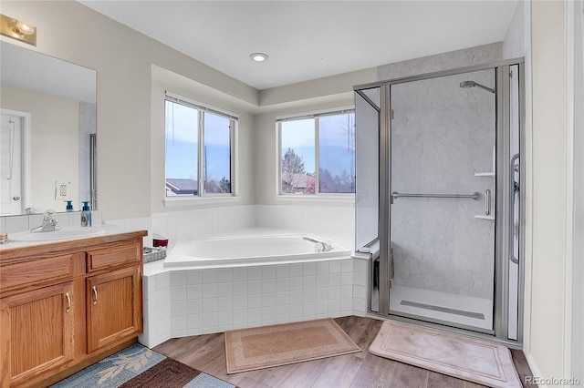 19939 E Belleview Ln, Centennial, CO 80015 - full bath with a garden tub, vanity, wood finished floors, and a stall shower