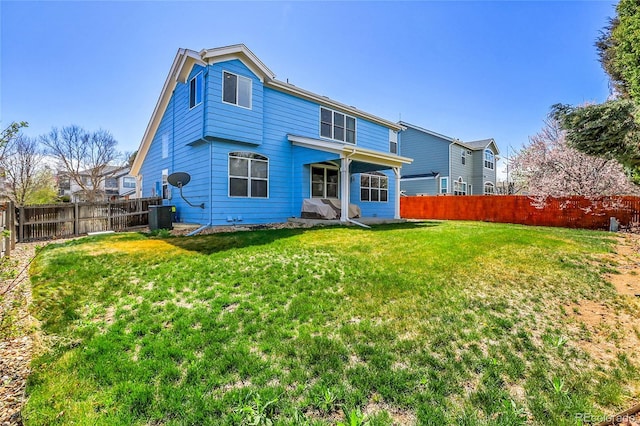 19939 E Belleview Ln, Centennial, CO 80015 - back of house featuring a fenced backyard, a yard, and central AC