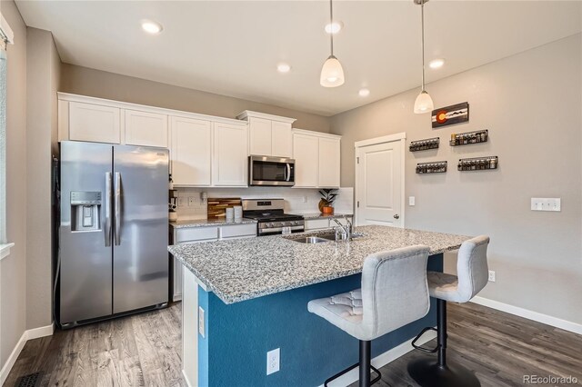 4781 Rosette St, Castle Rock, CO 80104 - kitchen featuring appliances with stainless steel finishes, a sink, dark wood-style floors, baseboards, and recessed lighting