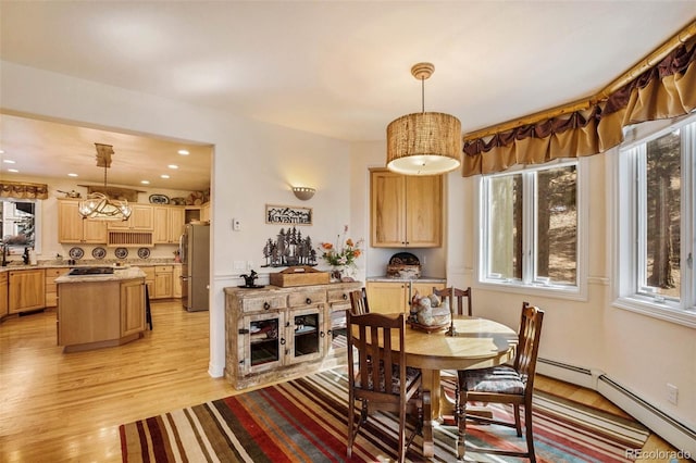 725 Sun Valley Dr, Woodland Park, CO 80863 - dining room featuring light wood-type flooring, healthy amount of natural light, a baseboard radiator, and recessed lighting
