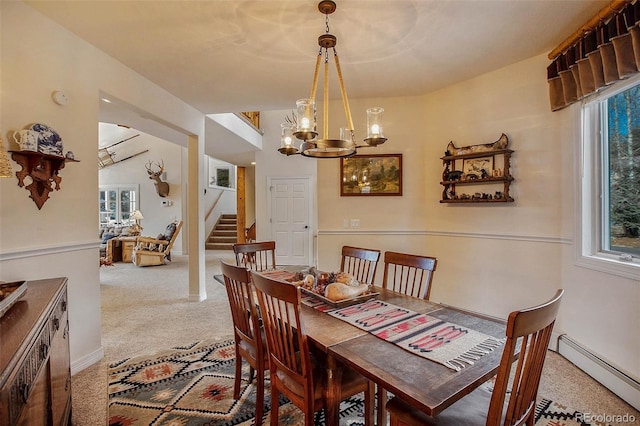 725 Sun Valley Dr, Woodland Park, CO 80863 - dining room with a baseboard heating unit, stairway, carpet, and a chandelier