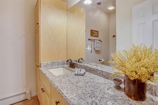 725 Sun Valley Dr, Woodland Park, CO 80863 - bathroom featuring baseboard heating, vanity, ceiling fan, and baseboards