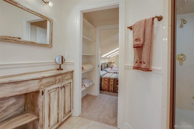 725 Sun Valley Dr, Woodland Park, CO 80863 - bathroom featuring connected bathroom, vanity, built in shelves, and a shower
